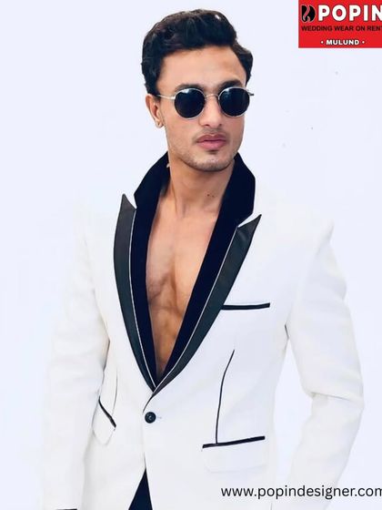 A close-up of our popular white tuxedo jacket with a black satin lapel. This shot highlights the sharp tailoring and modern design, perfect for making a bold style statement.