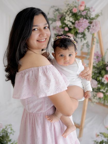 A mother and baby portrait from our Mother's Day mini-sessions, set against a beautiful floral backdrop.