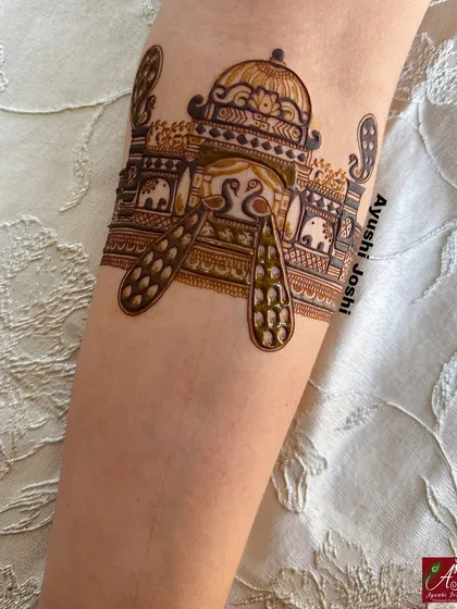 An armband design featuring a royal palace with peacocks, a classic element for any bridal mehendi.