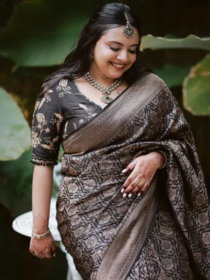 A candid shot of a client in her black Banarasi saree and custom floral embroidered blouse. The outfit is ideal for an elegant evening function.