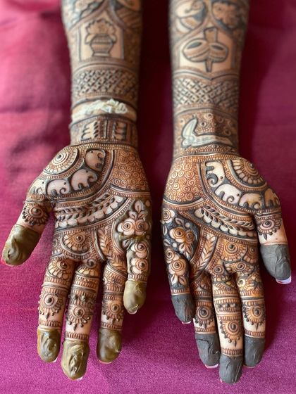 A detailed look at a bridal design featuring rows of elephants and ceremonial pots (kalash), symbolizing abundance and auspicious beginnings.