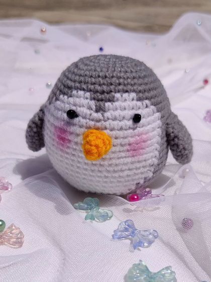 A chubby, round penguin plushie, perfect as a small toy or charm.