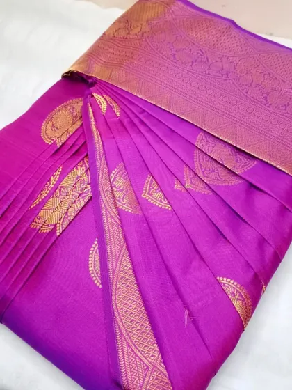 A rich purple silk saree with gold motifs.