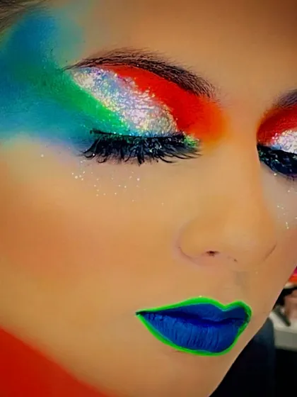 A creative makeup look inspired by the Indian flag, using glitter and bold colors for a Republic Day celebration.