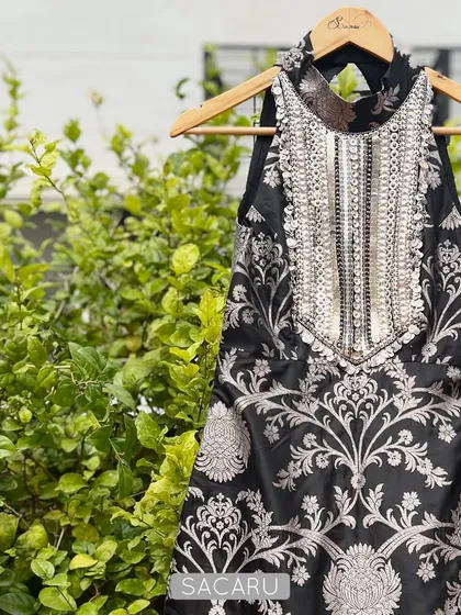 A statement piece for any festive occasion. This black brocade halter top is defined by its heavily hand embroidered neckline, featuring a dense pattern of silver metal sequins and beads.