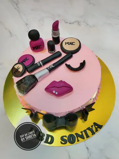 For the makeup guru, this cake brings all the glam. It's topped with a variety of edible, handcrafted makeup items, including lipstick, eyeshadow, and brushes, all modeled after a popular brand.
