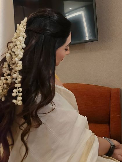 A close-up of my South Indian hairstyle for an event in Kochi. I pay attention to every detail to ensure my look complements the destination's culture.