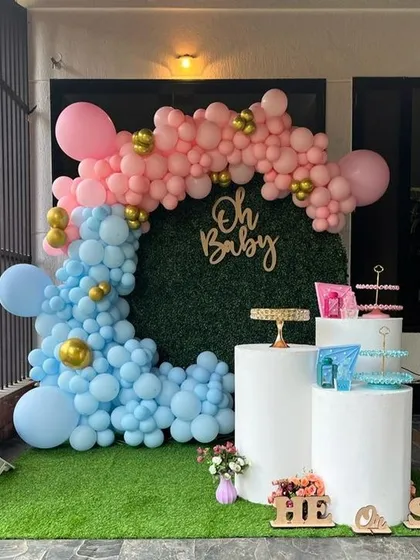 A modern and popular 'He or She' gender reveal party. I used a stylish grass wall backdrop with a pink and blue organic balloon garland to create the perfect photo opportunity for the happy couple.
