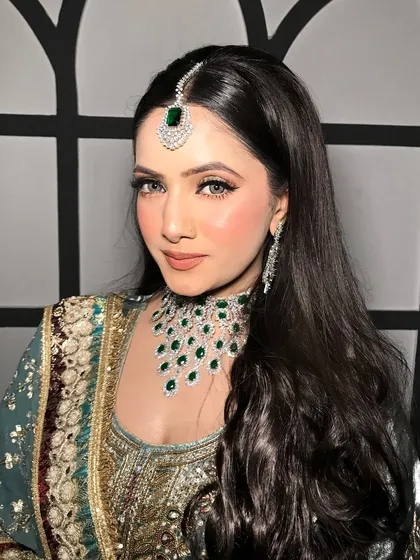Another angle, showing her sleek hair and the sparkle of her jewelry.