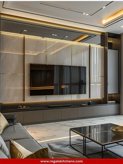 A grand, cinematic TV wall with marble panels and integrated lighting. The dark cabinetry and shelving frame the television, creating an immersive viewing experience.