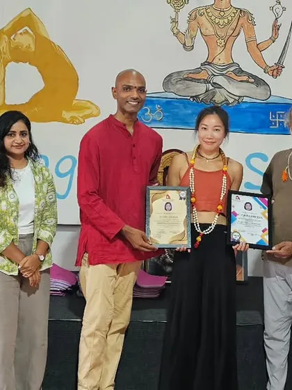 Another proud graduate from the Thailand intensive workshop, holding her certificates for various yoga disciplines.