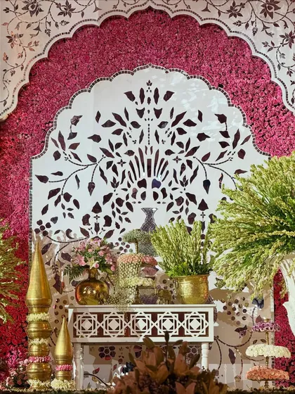 A close-up of the detailed craftsmanship. This panel, featuring a tree-of-life motif, is framed by a wall of vibrant pink flowers, showcasing our focus on intricate, artistic elements.