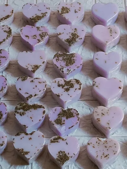 A large batch of the lavender milk heart soaps, with and without buds.