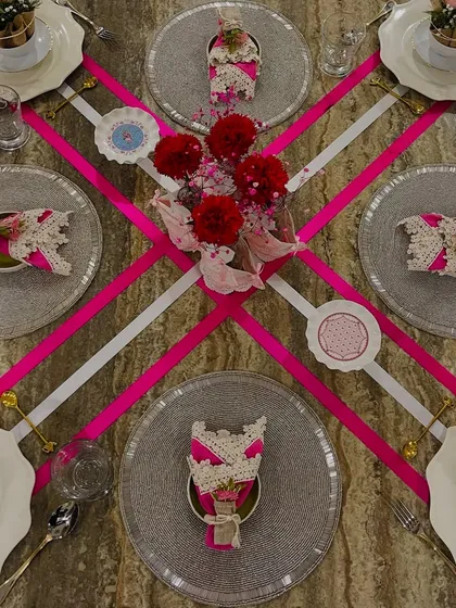 This pink ribbon-themed tablescape was designed to celebrate with grace and purpose. The bold geometric lines of the ribbons contrast with soft florals, creating a modern and elegant look perfect for a special brunch or awareness event.