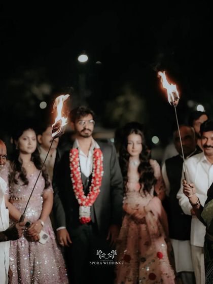 The groom's procession at night, lit by traditional torches, creating a dramatic and unforgettable entrance.