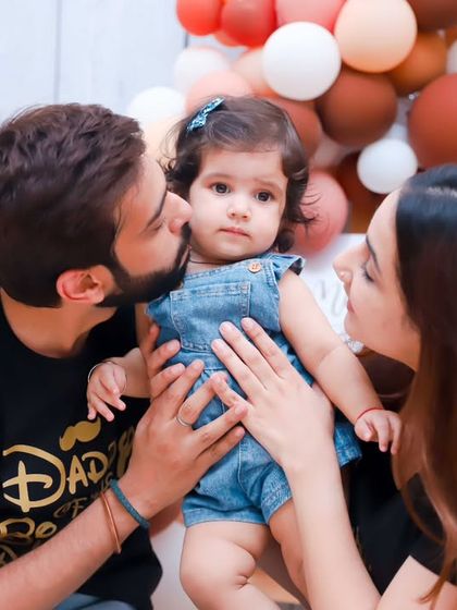 A beautiful color portrait of a family celebrating their daughter's first birthday. We capture the love and pride in the parents' eyes.