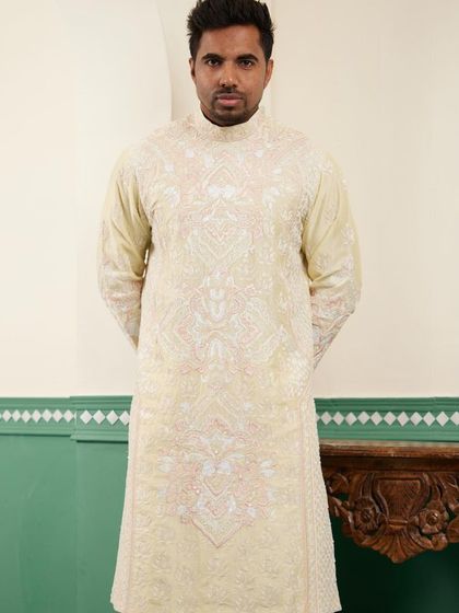 Our canary yellow kurta, featuring dense, all-over hand-embroidery in white and blush pink threads.