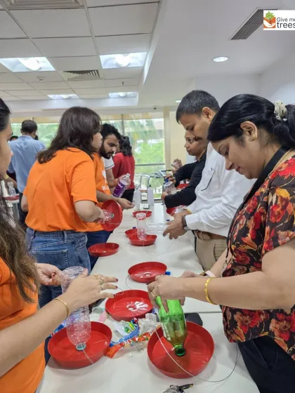 A line of employees at Fiserv, each working on their own bird feeder. We provide all the materials and guidance to make the workshop a success.