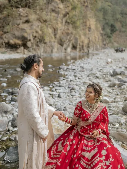 After their wedding ceremony in Rishikesh, we took some time for portraits by the river. This quiet moment of them holding hands shows the beginning of their new journey together.