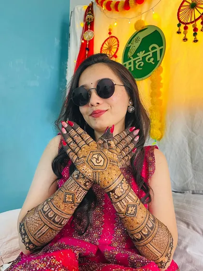 A happy bride with a cool attitude. Her sunglasses and smile, paired with her stunningly intricate mehendi, create a perfect picture of a modern bride.