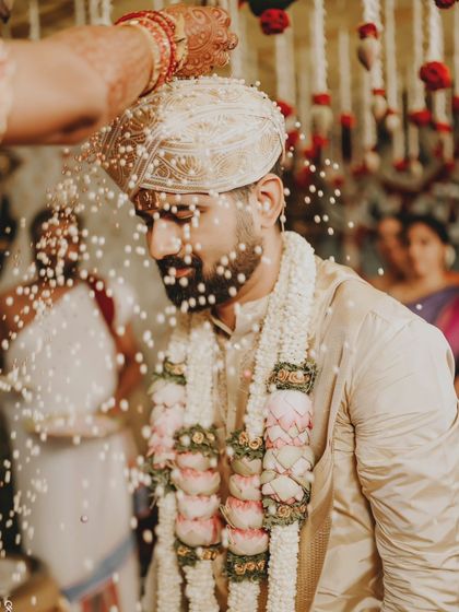 The Akshata ritual, where rice grains are showered on the groom as a blessing. A key moment in a Hindu wedding.
