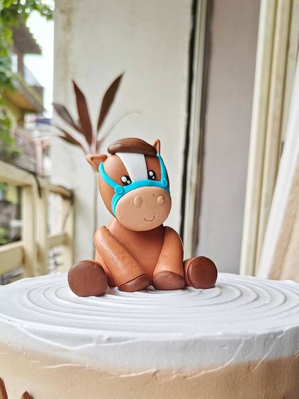 A close-up of the hand-sculpted fondant pony. I love creating these little characters to bring a theme to life.