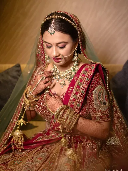 A close-up of the bride, showing the beautiful details of her makeup, jewelry, and of course, her mehndi. Every element comes together to create a perfect bridal look.
