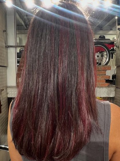 This shot shows the subtle dimension of the Cherry Cola hair colour. The deep red tones are woven through the hair for a result that is rich and multi-faceted.