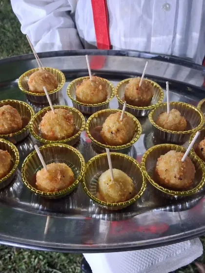 Crispy fried cheese and potato balls served on a platter, ready to be served to guests at a birthday party in Vashi.