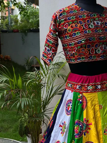 A close-up view of the intricate embroidery on the blouse. The mix of colors and patterns is a testament to the skilled artisans I work with.
