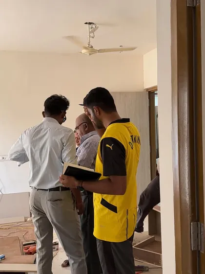 A team huddle on-site to ensure everyone is aligned on the day's tasks.