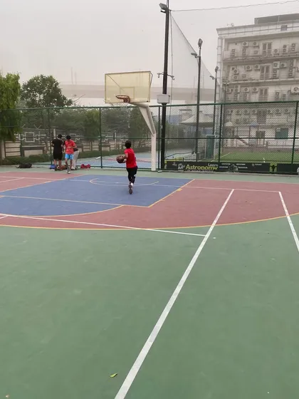 A lone player practices his dribbling on the court. The dedication continues even when the drills are over.
