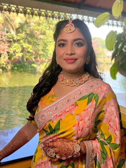 A close-up of the Haldi look, her smile radiating happiness and her skin glowing.
