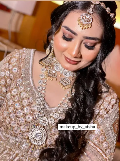 This bride's golden lehenga with silver jewellery is a stunning combination. I created a dramatic smokey eye to match the glam.
