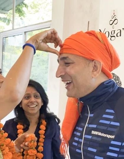 A teacher is honored by a student during the certification ceremony, a heartfelt exchange that marks the end of the course.