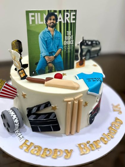 The finished cake for Jitendra Kumar, celebrating his work with elements like a Filmfare cover, a cricket bat, and movie reels.