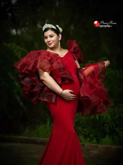 The Ruth gown, styled with a tiara and detachable ruffled sleeves. This dress is all about creating a look of regal elegance.