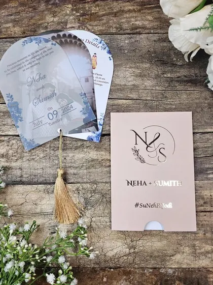 Here is a unique fan-shaped invitation we created, featuring multiple translucent sheets that swivel out to reveal event details. The design incorporates the couple's photo, making it a truly personal keepsake for guests.