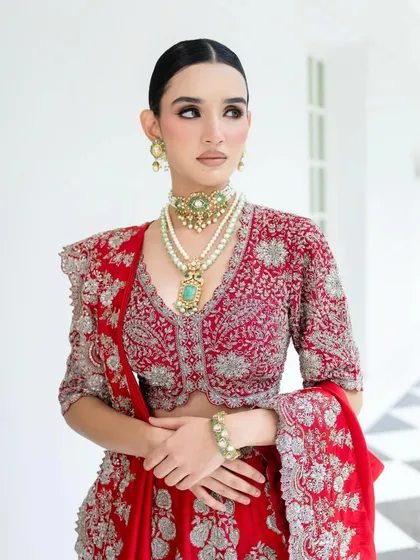 The magic is in the details. This close-up on a Jayanti Reddy bridal look showcases how I layer heritage jewelry to complement the intricate embroidery of the blouse. Every element, from the pearl strings to the pop of turquoise, is chosen to build a rich, regal narrative.