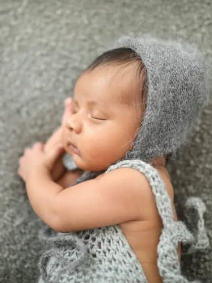 So sleepy and content in a hand-knitted outfit. I have a collection of delicate props like this to make your newborn's first photoshoot extra special.