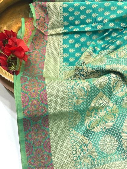 The border of our Chanderi saree. This angle highlights the intricate patterns and the blend of colors along the border, demonstrating the fine craftsmanship of the weavers.
