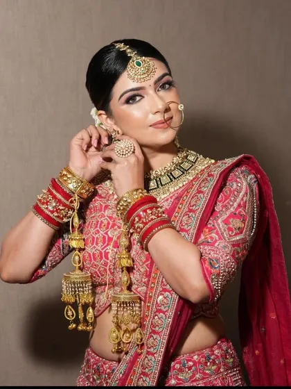 Another look at the fine details of our bridal wear. The combination of the embroidered blouse, heavy jewelry, and kaleeras makes for a picture-perfect wedding moment.
