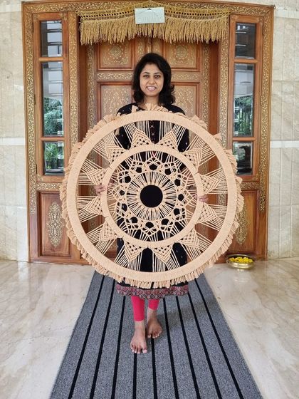 This immense macrame mandala was a labor of love, taking over 18 hours of meticulous handiwork. Every knot and pattern was customized to create an extraordinary piece of wall art for our client.