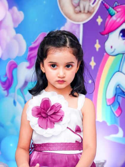 A magical 'Mermaid' themed birthday party, with shimmering blue and green decor, seashell props, and mermaid cutouts, creating an enchanting underwater world.