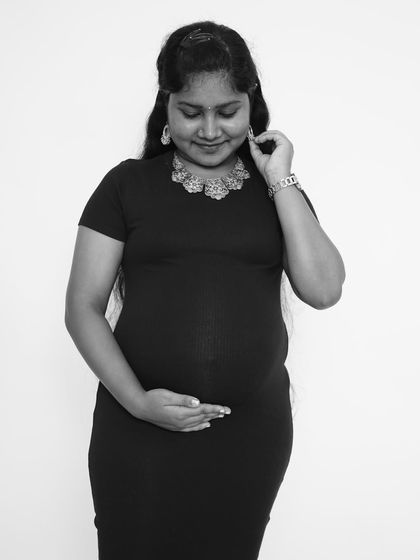 A beautiful black and white portrait of the mother-to-be. The focus on her expression and the gentle curve of her bump creates a simple yet stunning image.