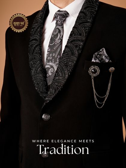 Where elegance meets tradition. A close-up on a black tuxedo with a heavily embroidered lapel and a patterned tie, showing the fusion of styles.