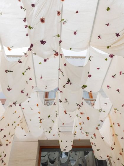 A close-up of the organic fabric canopies, where every single flower was stitched on-site by our team. The flowers were sourced from local growers but looked nothing short of exotic.