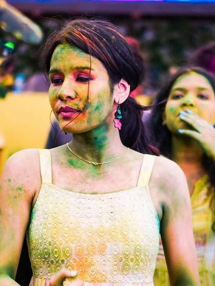A guest enjoying the colorful chaos of the Holi party. I use only organic colors to ensure everyone has a safe and fun time.