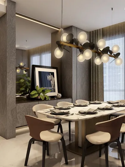 In the serene neighborhood of Walkeshwar, this dining space redefines modern luxury. A sculptural light fixture hangs above the table, while rich textures of beige marble, ash veneer, and smoked mirrors create a cohesive and strikingly minimal aesthetic.