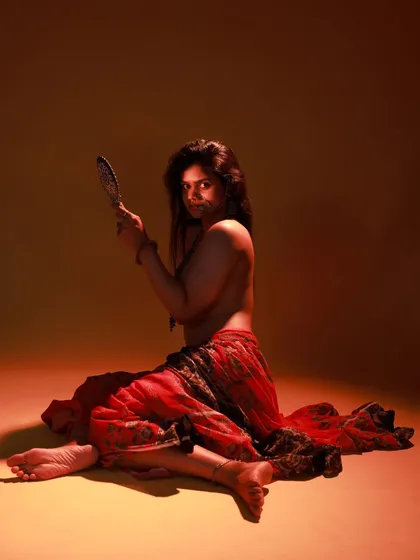 A direct-to-camera look from the same series. The model's expression is powerful, and the dramatic lighting enhances the mood.